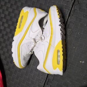 Undefeated x Nike Air Max 90 sneakers in the 'White Optic Yellow' colorway. 